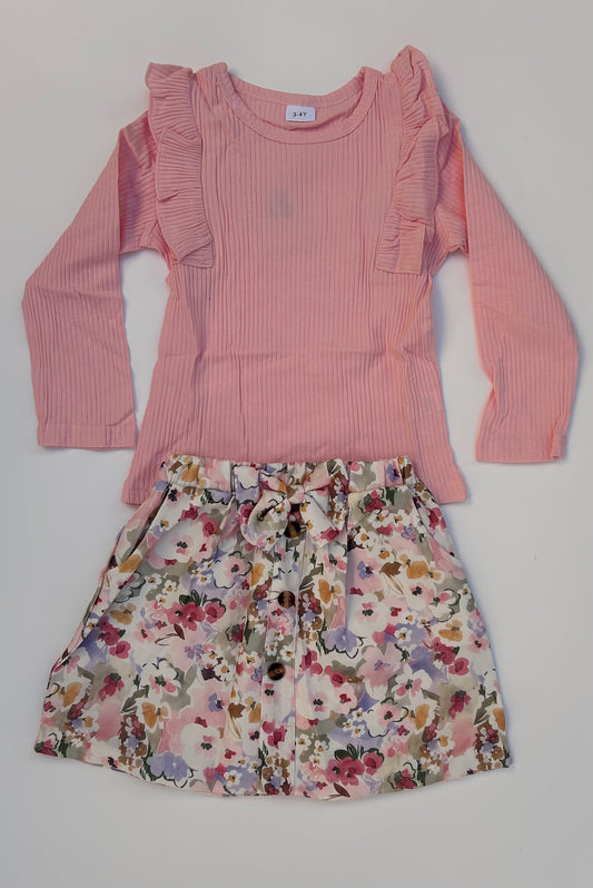 IM baby pink top with flowery skirt