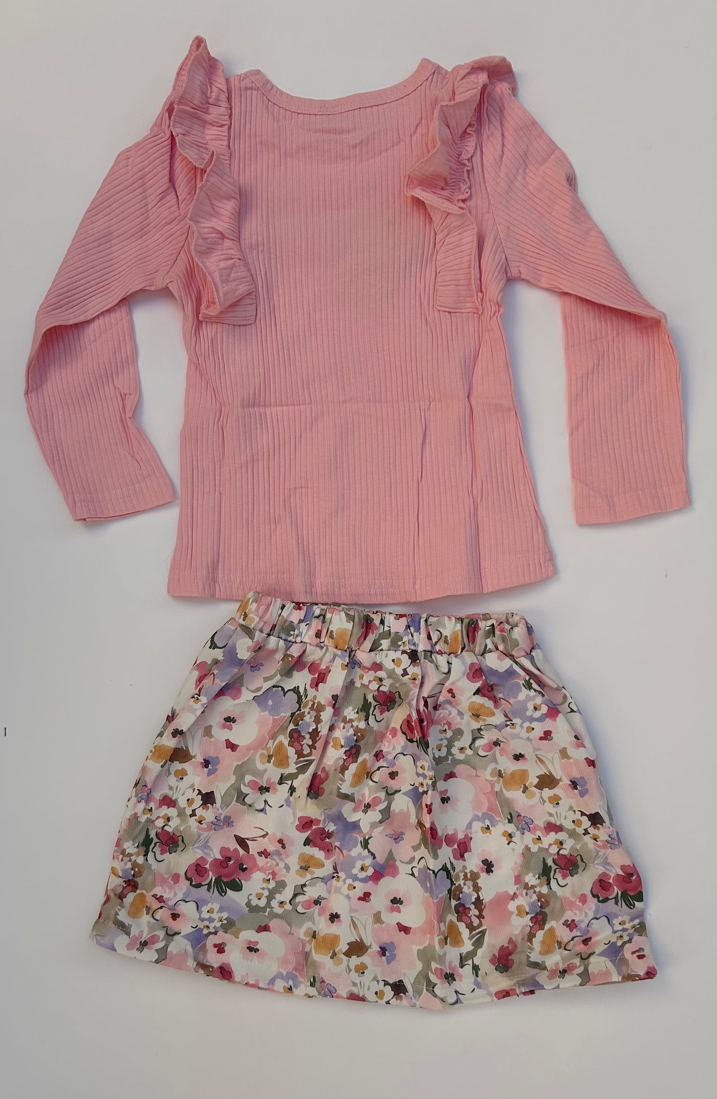 IM baby pink top with flowery skirt